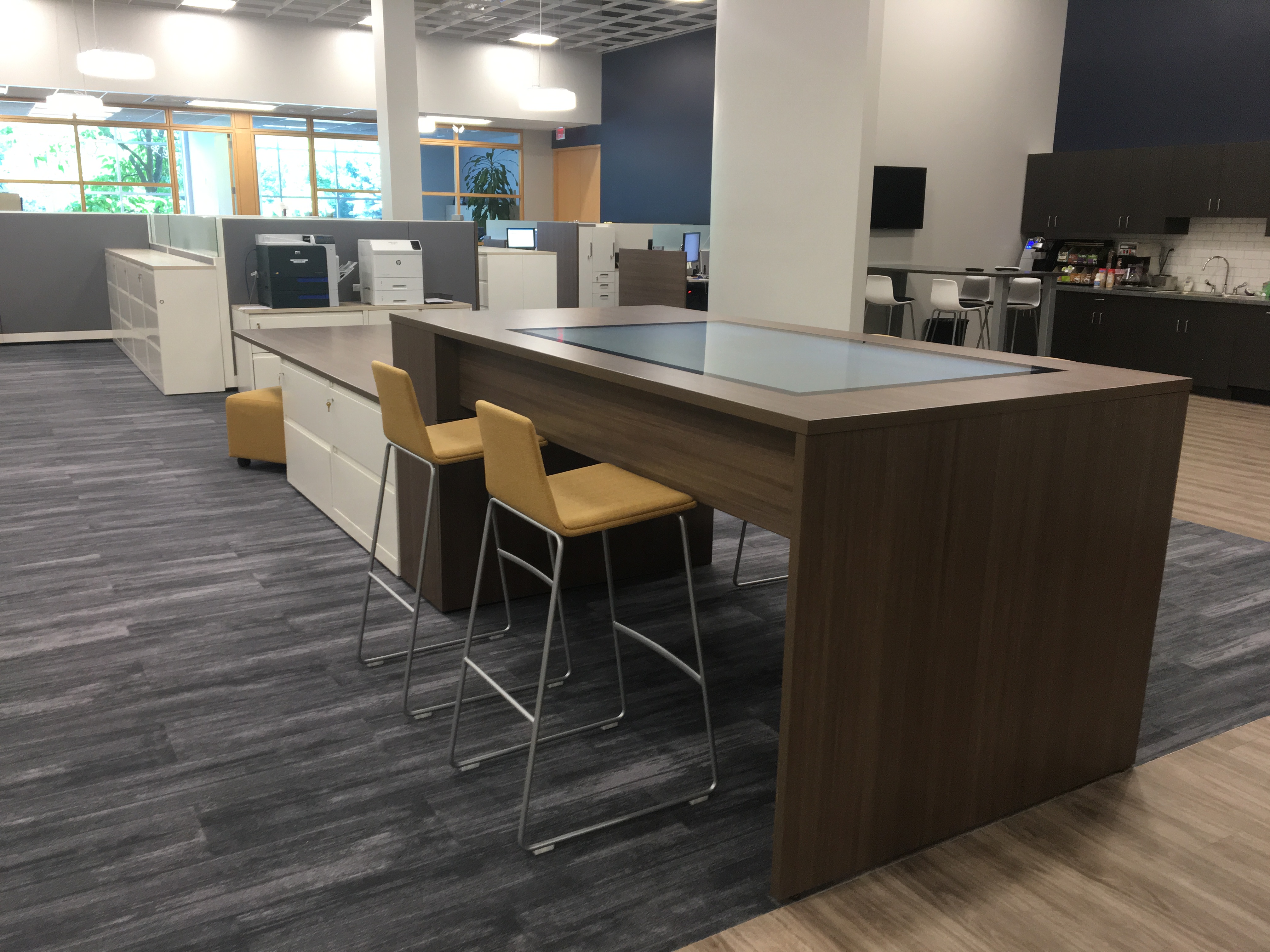 Technology integrated table with a screen in the table top.